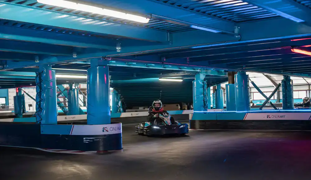 Group of drivers racing electric karts on the indoor circuit