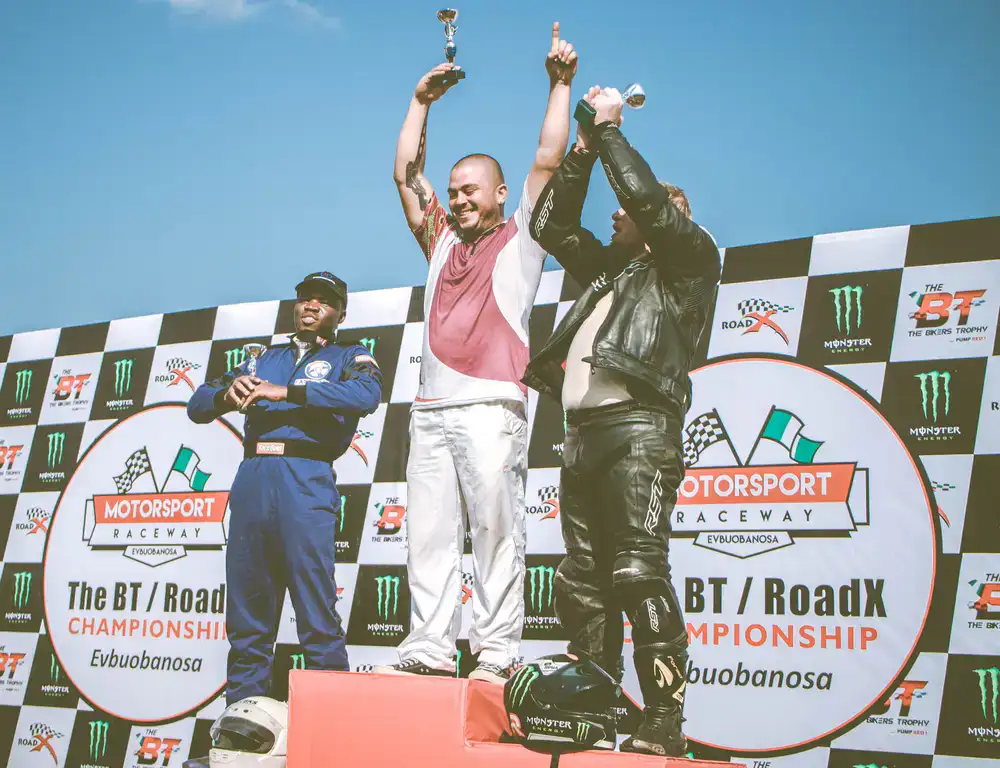 Winners celebrating on the podium with trophies