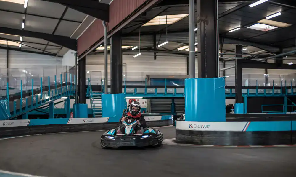 Electric kart speeding around an indoor corner